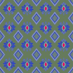 Olive green and blue ikat seamless pattern with ethnic floral and geometric diamond motifs. Vector textile design for fashion apparel, wallpaper, and home decor. © Nutthayakarn