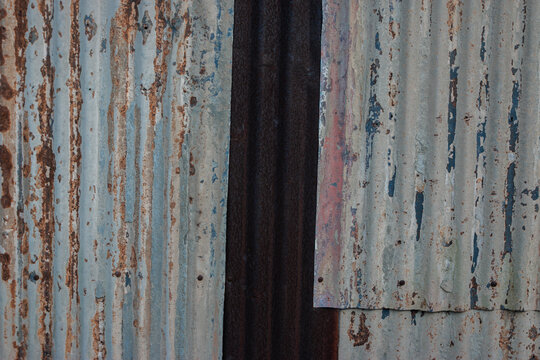 Close-up photo of a sheet of rusty galvanized iron, suitable for a background or other purposes.