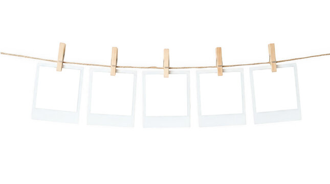 Blank instant photo frames on a string with clothespins, isolated on transparent background