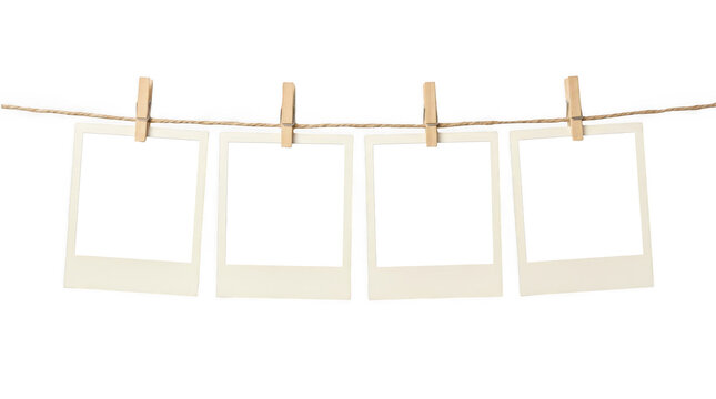 Polaroid frames on clothesline isolated on transparent background