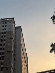 Low Angle Shot of High Rise Apartment Building at Sunset © muhammad