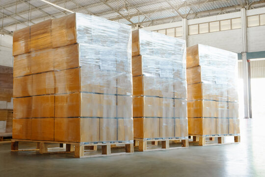Bulk of Package Boxes Wrapped Plastic on Wooden Pallets. Storage Distribution Warehouse. Cardboard Boxes. Supply Chain, Supplies Goods Shipment. Warehouse Shipping Logistics	
