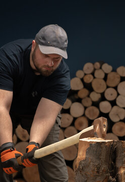 Man Splitting Firewood with an Axe in a Woodpile