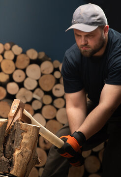 Man Splitting Firewood with an Axe in a Woodpile
