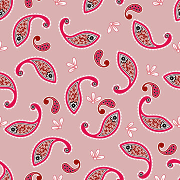 Elegant paisley seamless pattern featuring red ornamental motifs, floral details and white decorative accents on a dusty pink background, ideal for fabric, textile and wallpaper designs.