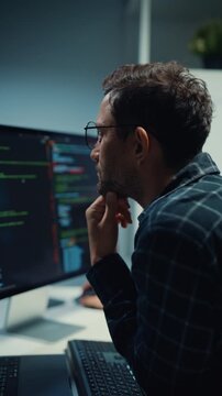 Vertical Screen : Focused caucasian software engineer work overtime late at night in tech office. Artificial intelligence, Dedicated freelance strategy, Database server debugging, Cybersecurity cloud.