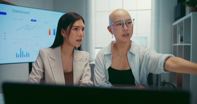 Young Asian business colleagues discussing project on computer at office. Corporate teamwork meeting, marketing report analysis, strategy planning development, professional manager advice concept.