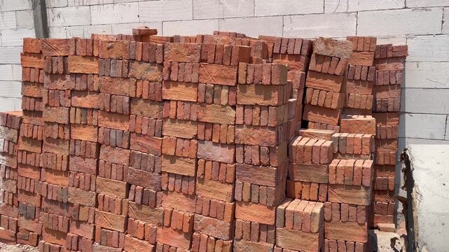 Wide View of Stacked Red Bricks on Housing Construction Site