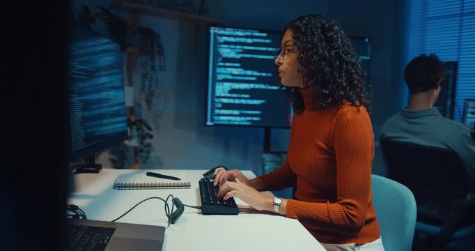 Group Adult male, female freelance typing write prompt AI bot IT app smart program nomad, video game, terminal with coding language, designer, big data center on desktop computer in office at night.