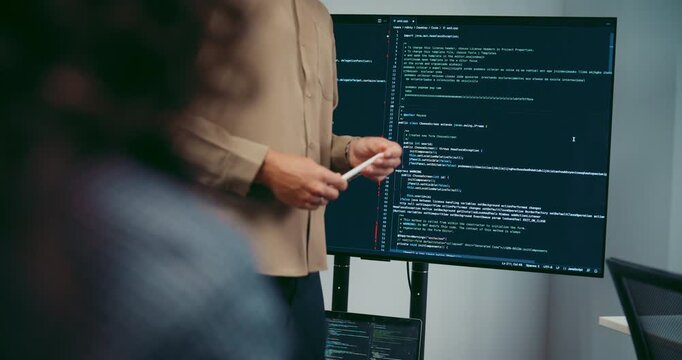 Diverse team software developer present coding on screen to colleague at office. Mentor coaching program leader, Creative startup teamwork discussion, Artificial intelligence system workshop concept.