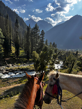 Mountains and lake below clouds in Kashmir