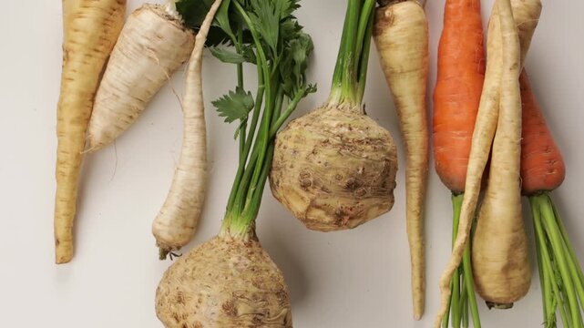  zoom winter vegetables celery carrot on ligt surface top view food