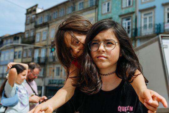 Young girls playing in central Lisbon street, Portugal