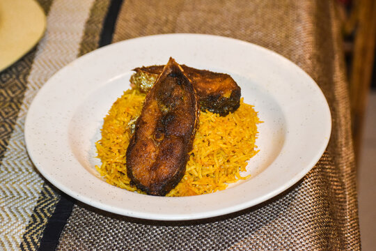 Two Big Size Fried Hilsa Fish Pieces on White Bone China Plate Which Are Cross Sectionally Cut