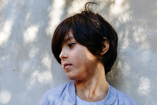 Portrait of Young Girl with Short Dark Hair Looking Away in Natural Light