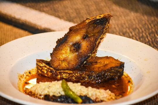 Two Big Size Fried Hilsa Fish Pieces on White Bone China Plate Which Are Cross Sectionally Cut