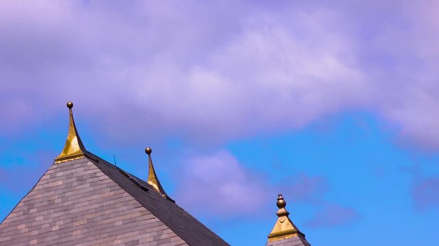 Close up of gold spires on the roof of a building