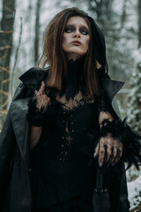 Obraz premium Mysterious witch walks in night forest. fog smoke, haze.Goth scary queen