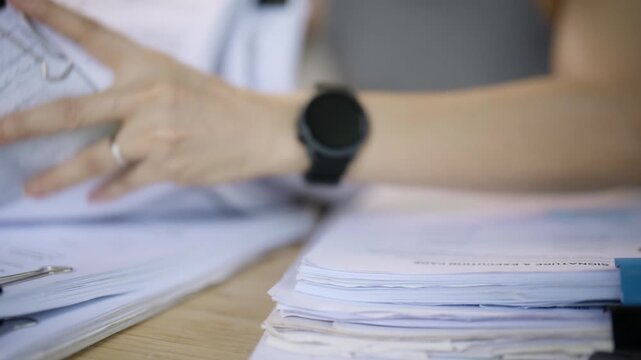 Woman Organizing Paper Documents While Working from Home