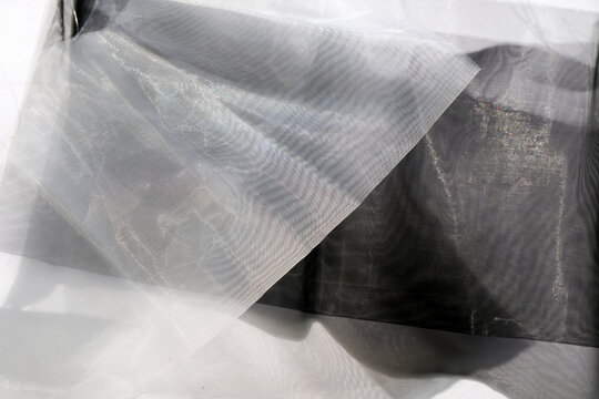 Sheer fabric with intricate patterns and layers displayed