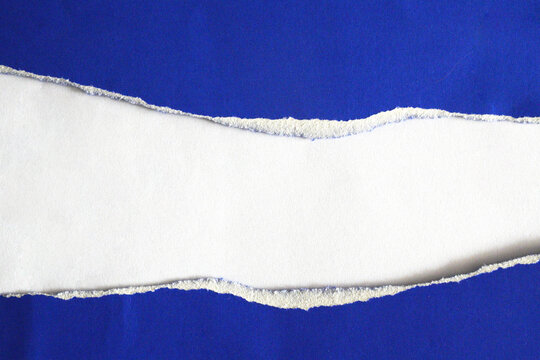 A torn piece of white paper on a blue background