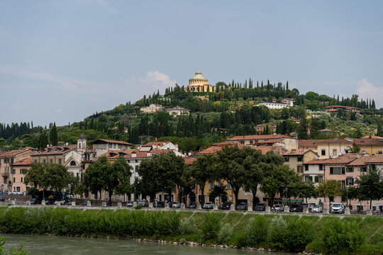 Verona old Buildings architecture, Italian Adige River, Italy Santuario della Madonna di Lourdes on Hill. Summer travel.