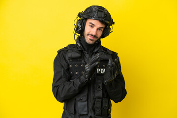 Fototapeta premium SWAT caucasian man isolated on yellow background applauding after presentation in a conference