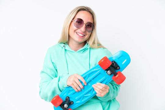 Young caucasian woman isolated on white background with a skate with happy expression