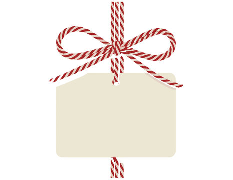 Blank paper gift tag hanging with a decorative red and white striped bakers twine bow