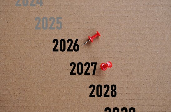 Printed years with a toppled stamp representing the outgoing year (2026) and the incoming year (2027)