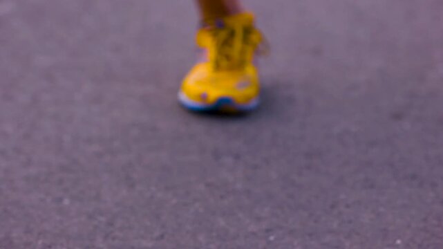 Close up of marathon athletes legs running on the pavement