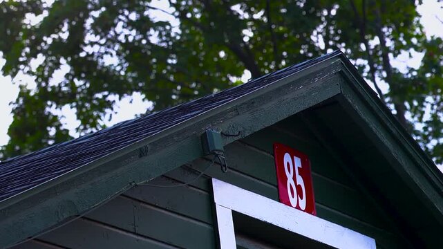 Close up of the roof of a horse barn with trees in the background
