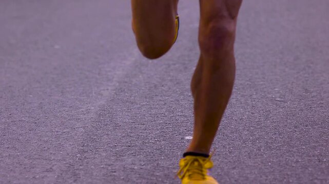 Close up of ultra marathon athletes legs as they flex while running