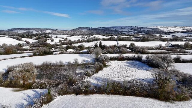 Snowy Patchwork Fields and Distant Hills