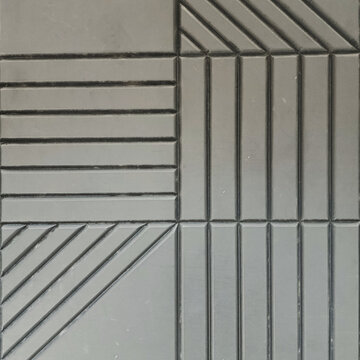 Close-up of geometric textured concrete wall tile with diagonal and parallel lines pattern