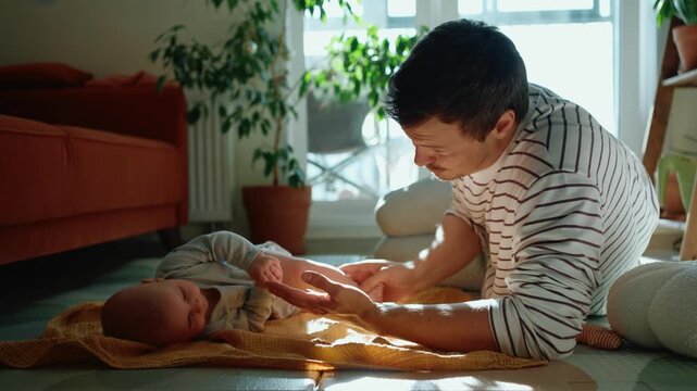 Devoted father assists his newborn son in rolling over on the floor of a sunlit living room, celebrating a significant developmental milestone and strengthening their bond