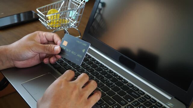 Person Using Laptop and Credit Card for Secure Online Shopping