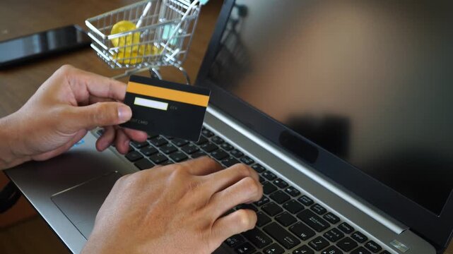 Person Making an Online Purchase Using a Credit Card and Laptop for Secure E commerce