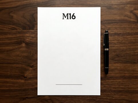 Blank white letterhead paper with m16 logo and black pen on a wooden desk surface blank page office supplies business branding corporate identity writing equipment wooden background flat lay