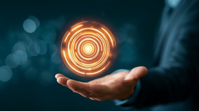 Glowing orange circular data visualization hovering above a man&rsquo;s hand, representing technological innovation and future concepts