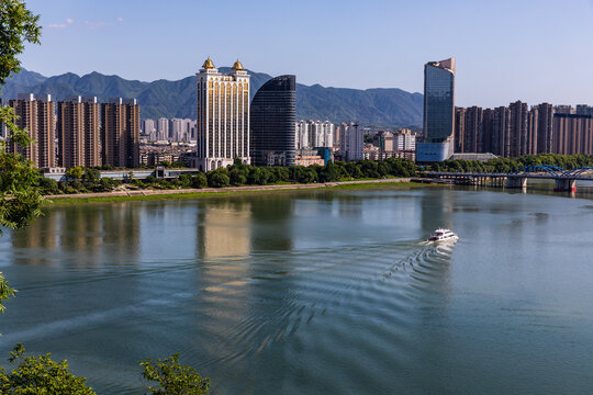 Riverside skyline of Tonglu County, Hangzhou, Zhejiang, China with boat and mountains