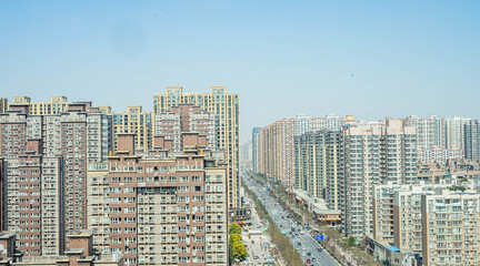 Fototapeta premium Dense Urban Cityscape with High-Rise Residential Buildings and Clear Sky