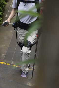 Hiker Using Wearable Leg Exoskeleton While Climbing Outdoor Steps