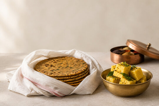 Wrapped thepla and dhokla with spice box, Indian food tradition concept