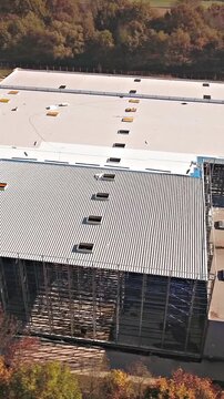 Flying around a new build warehouse building in bird's eye view