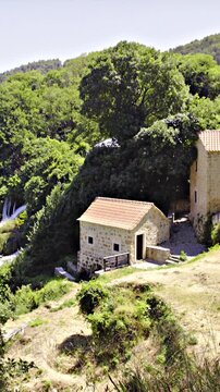 Old traditional house next to paradise waterfalls wide shot