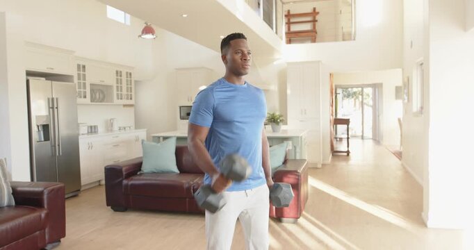 Lifestyle videos indoor of people doing activities at home, Lifting dumbbells, man exercising in mod