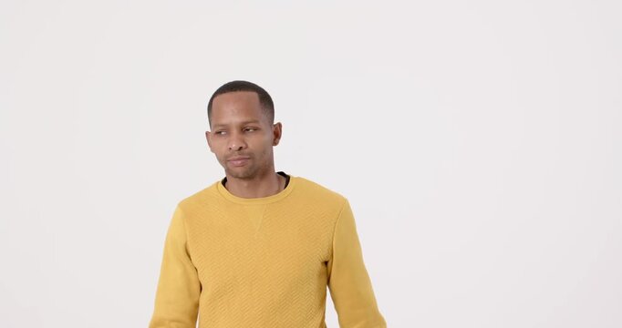 High-speed photography for dynamic scenes, man in yellow sweater looking to side with neutral expres