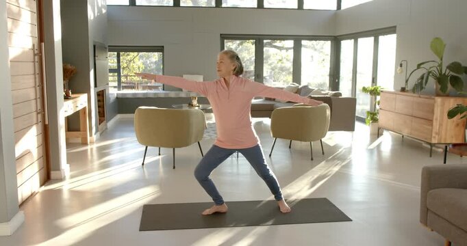 Lifestyle videos indoor of people doing activities at home, practicing yoga, woman stretching on yog