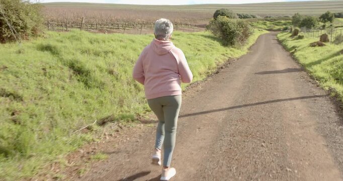 Lifestyle videos outdoor of people doing activities, jogging on dirt path, woman enjoying outdoor ex